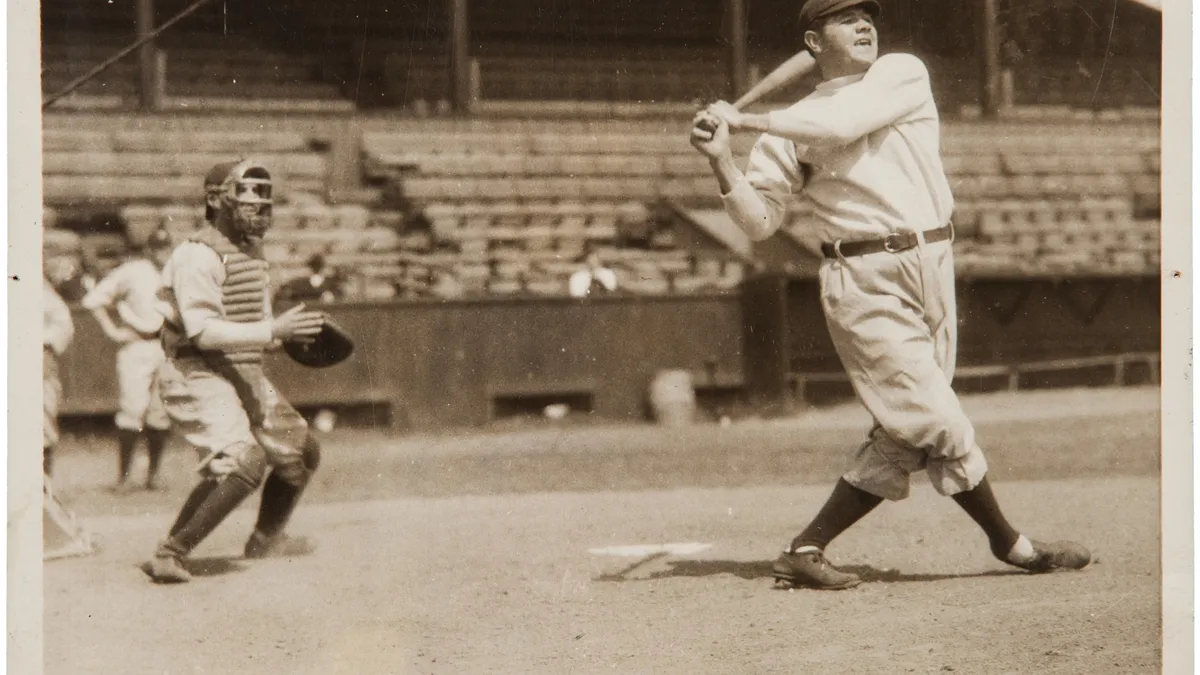 Babe Ruth in a Yankees uniform at full swing during batting practice, about 1921