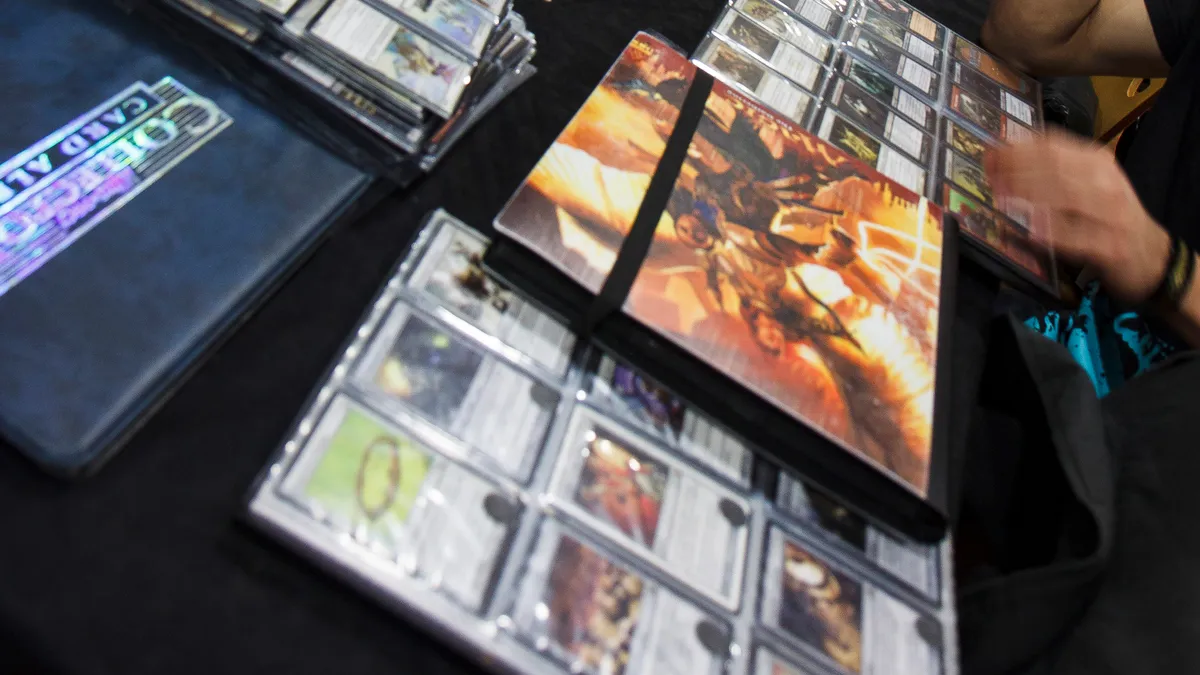 Binders of Magic: The Gathering cards laid out for trading